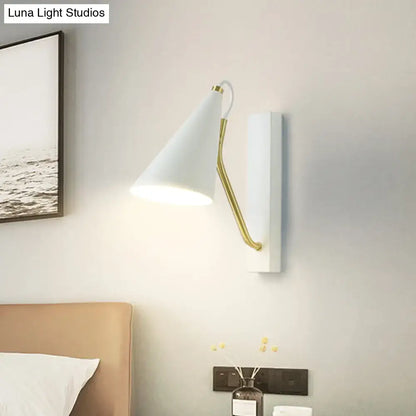 Modern white wall lamp with gold articulated arm featuring a conical white black finish sconce for bedroom use