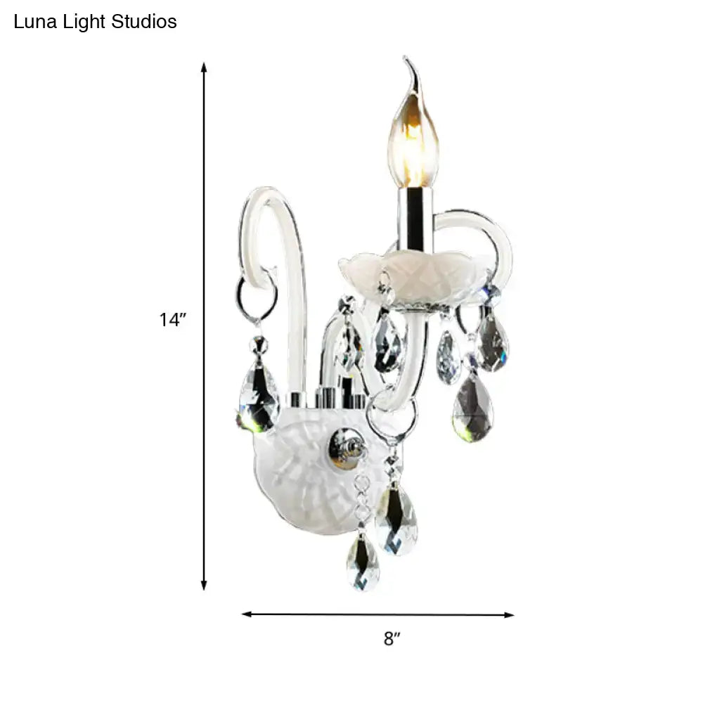 Elegant white wall sconce light with frosted glass base chrome accents and teardrop crystal decoration for living room