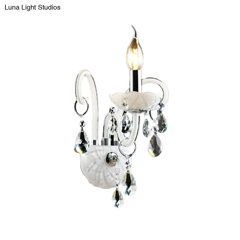 Modern white wall sconce light with teardrop crystal decoration featuring a delicate white crystal chandelier design