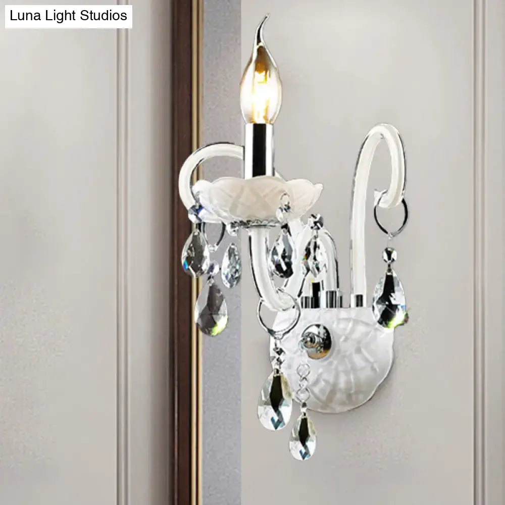 Elegant white wall sconce light with chrome accents and teardrop crystal decoration for modern living rooms