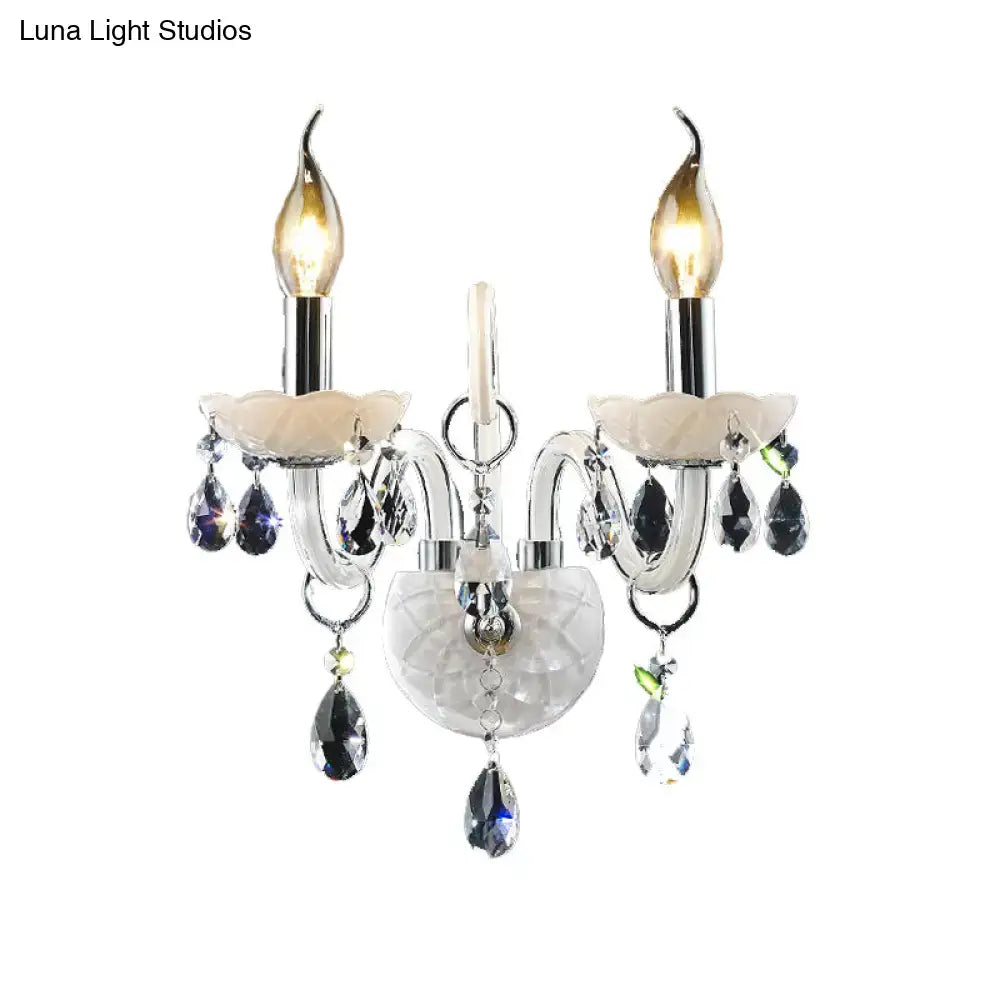 Elegant modern white wall sconce light with teardrop crystal decoration and two-light crystal chandelier design