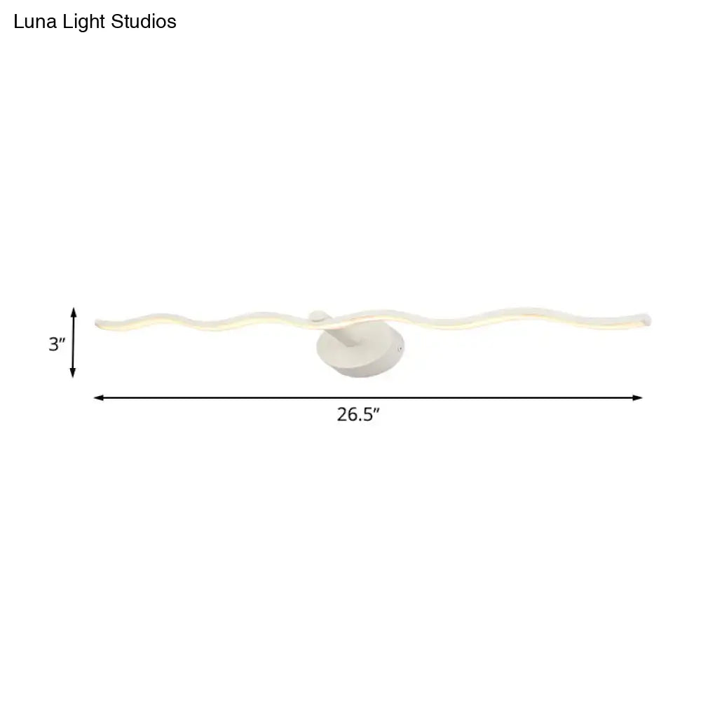 A modern white wave design led vanity light fixture with a wavy acrylic body and circular base for bathrooms