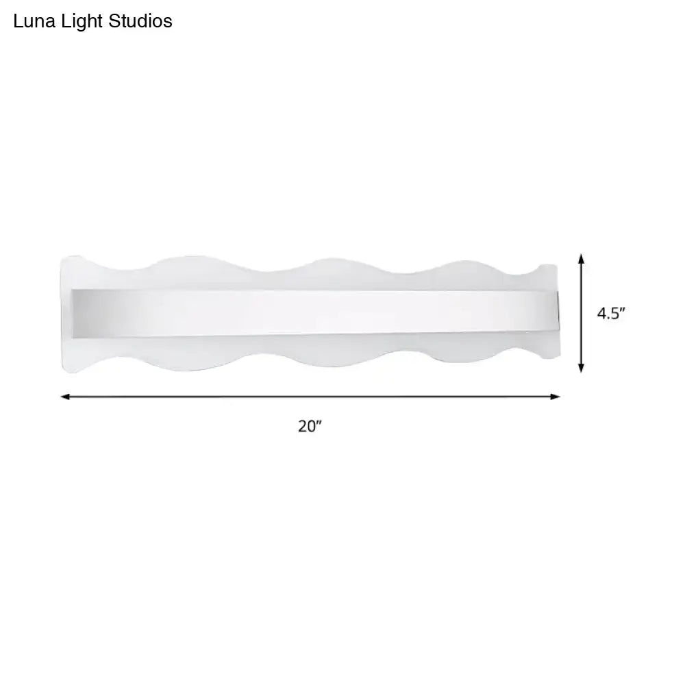 Modern white 20-inch wave led light fixture with sleek finish providing white warm bathroom wall sconce illumination