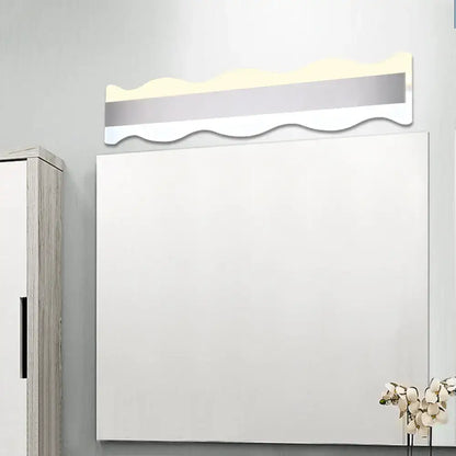 Modern white rectangular mirror with wavy illuminated silver trim featuring a white warm light fixture for bathrooms