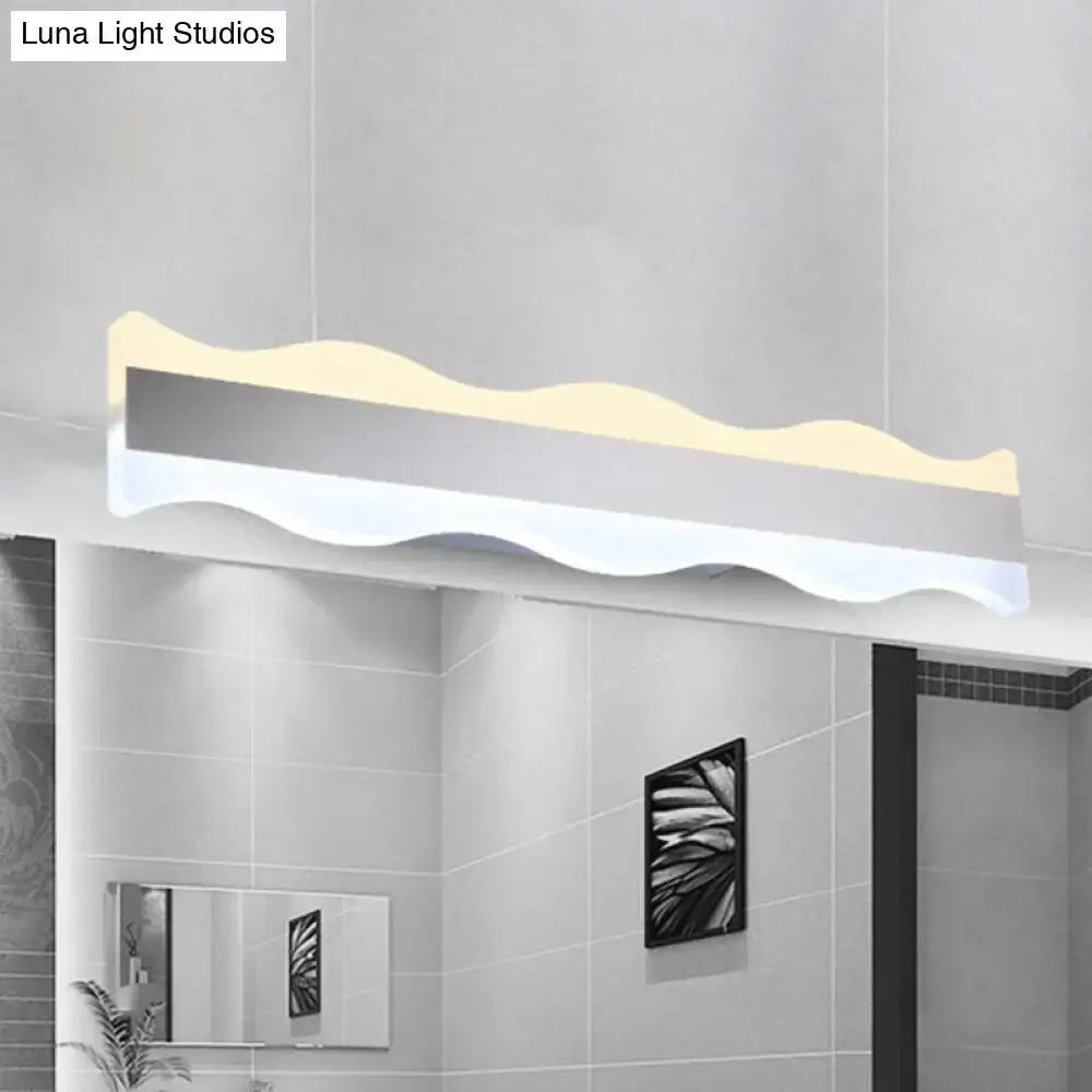 Modern white wave led light fixture with sleek silver and white finish designed as a bathroom warm white sconce