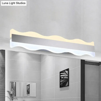 Modern white wave led light fixture with sleek silver and white finish designed as a bathroom warm white sconce