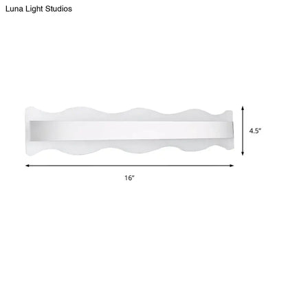 Modern white wave LED light fixture with a sleek wavy design and rectangular panel for warm bathroom lighting