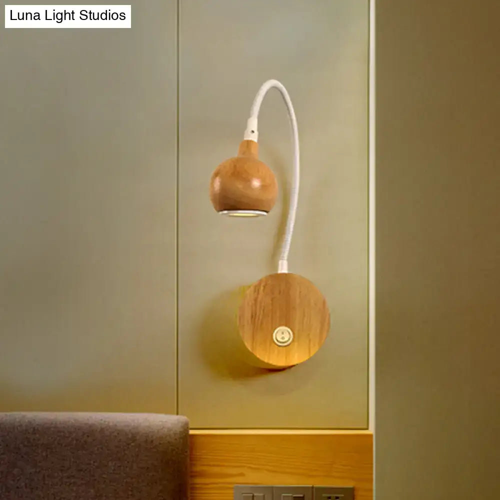 Modern wood adjustable arm wall light with a warm wood finish and white flexible gooseneck for bedroom reading
