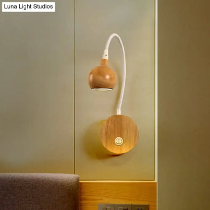 Modern wood adjustable arm wall light with a warm wood finish and white flexible gooseneck for bedroom reading