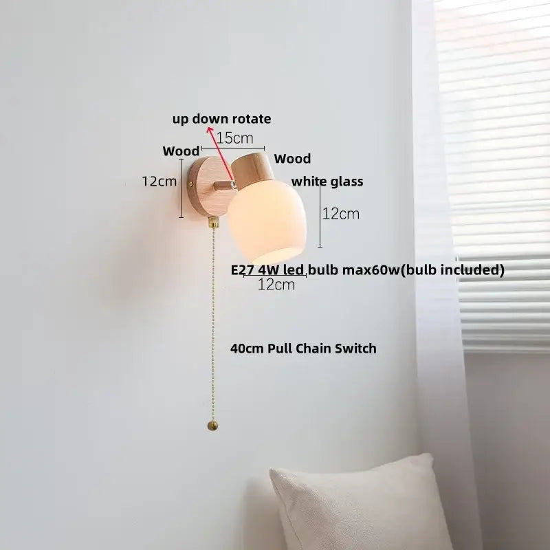 Minimalist wall sconce with light wood finish, white amber glass led shade, and brass pull chain switch by decorbites
