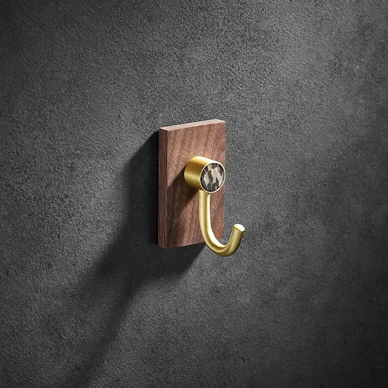 Modern wood and brushed gold wall hook with sleek brass brushed hook and patterned stone on dark wood plaque decorbites brass brushed