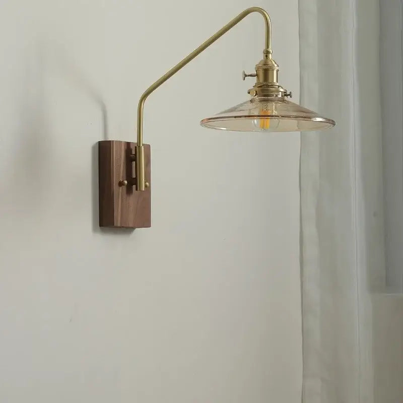 Modern brass-finished wall sconce with wooden base and clear glass shade for bedroom or stair glass copper led wall lighting