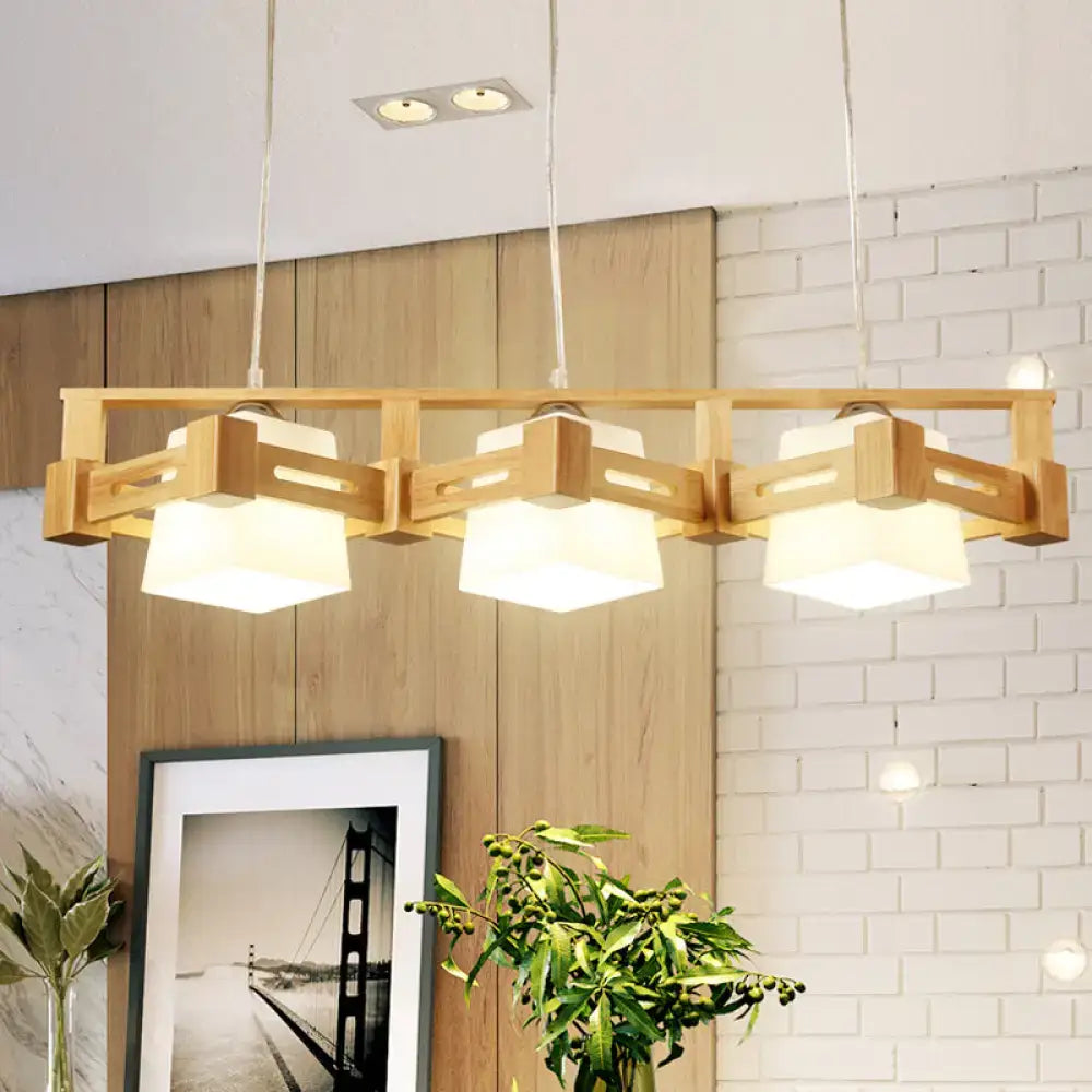 Decorbites modern cubic pendant lamp with wood cage and three beige milk frosted glass shades for island lighting