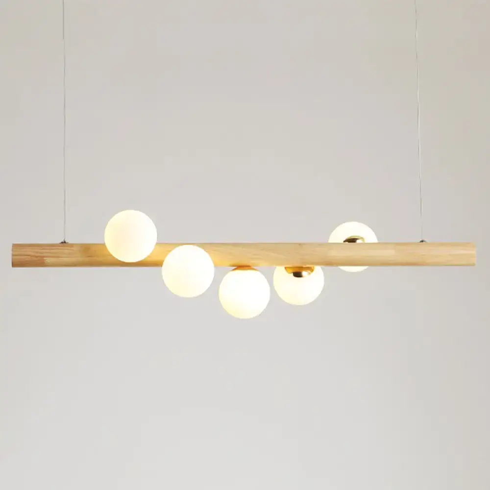 DecorBites™ minimalistic milk glass suspension light with natural wood bar and five frosted globe bulbs for dining room