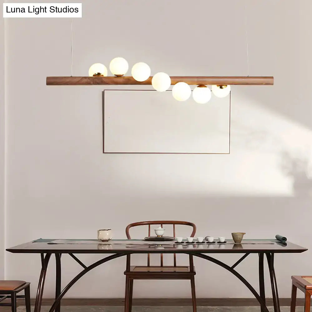 DecorBites minimalistic milk glass suspension light with wooden bar and frosted globe bulbs for dining room