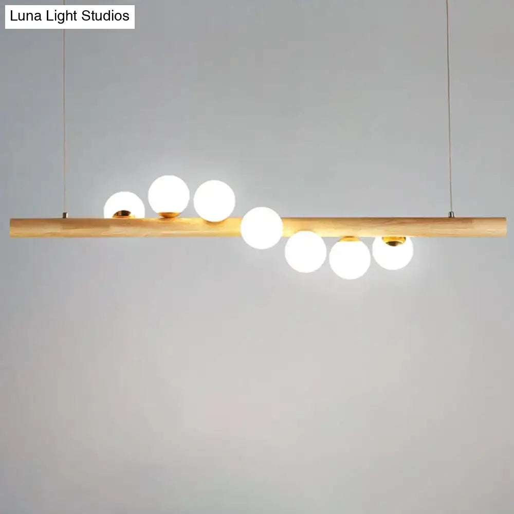 DecorBites minimalistic milk glass suspension light with wooden bar and frosted globes for dining room lighting