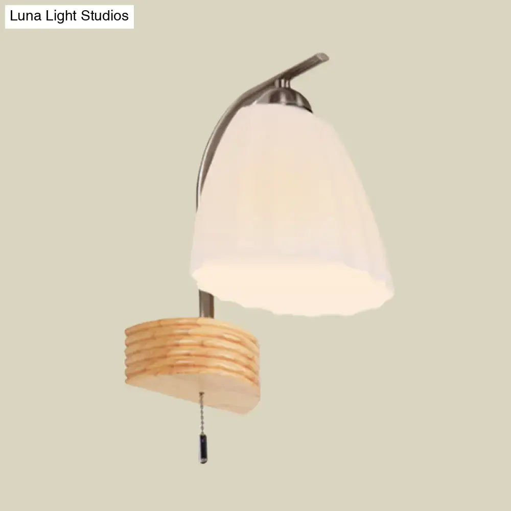 Modern wall lamp with ribbed glass flared off-white shade and woven wooden base for bedroom lighting