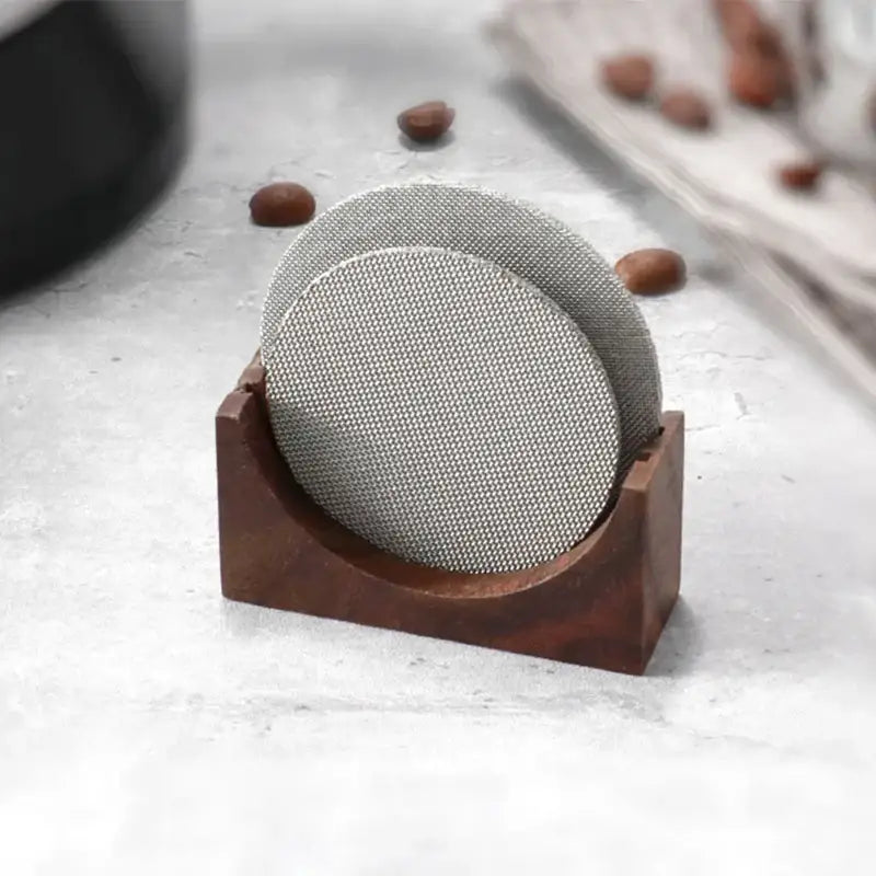 Silver mesh coasters in a dark wood decorbites coffee filter stand for modern coffee filter storage and kitchen decor