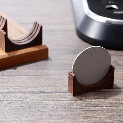A sleek dark brown wooden decorbites coffee filter stand holding a round textured gray fabric coaster