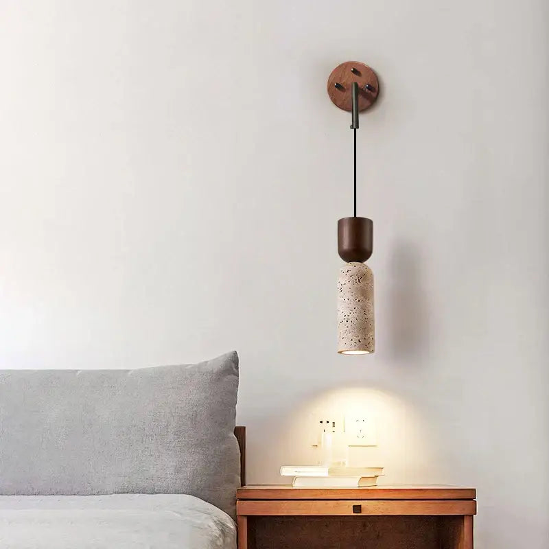 Modern wood and travertine led wall lamp with dark wood base, black rod, and beige terrazzo cylindrical shade