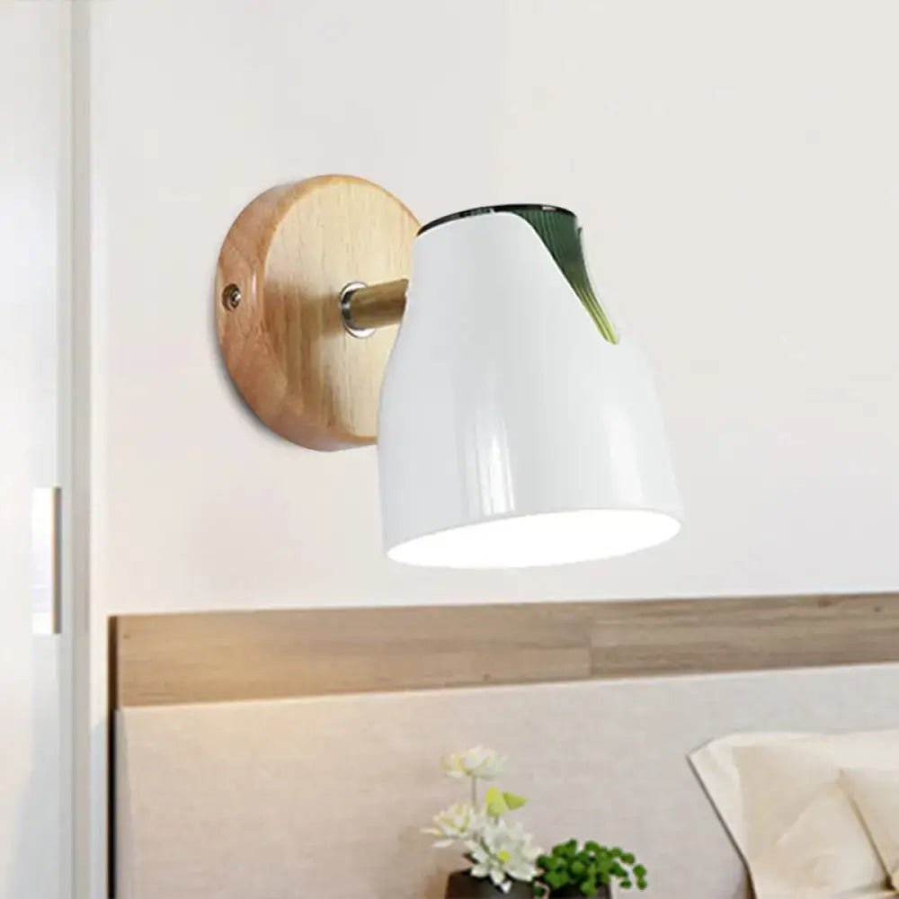 Modern wall light featuring a white ceramic shade with a green leaf accent and wooden backplate metallic bud shade design