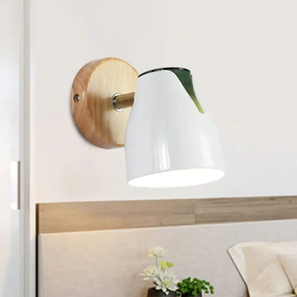 Modern wall light featuring a white ceramic shade with a green leaf accent and wooden backplate metallic bud shade design