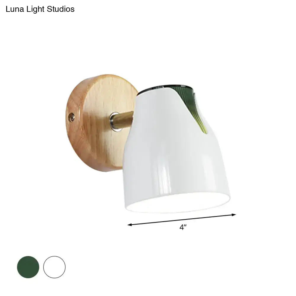 Modern wood and white ceramic wall light with green leaf accent and metallic bud shade as a light source