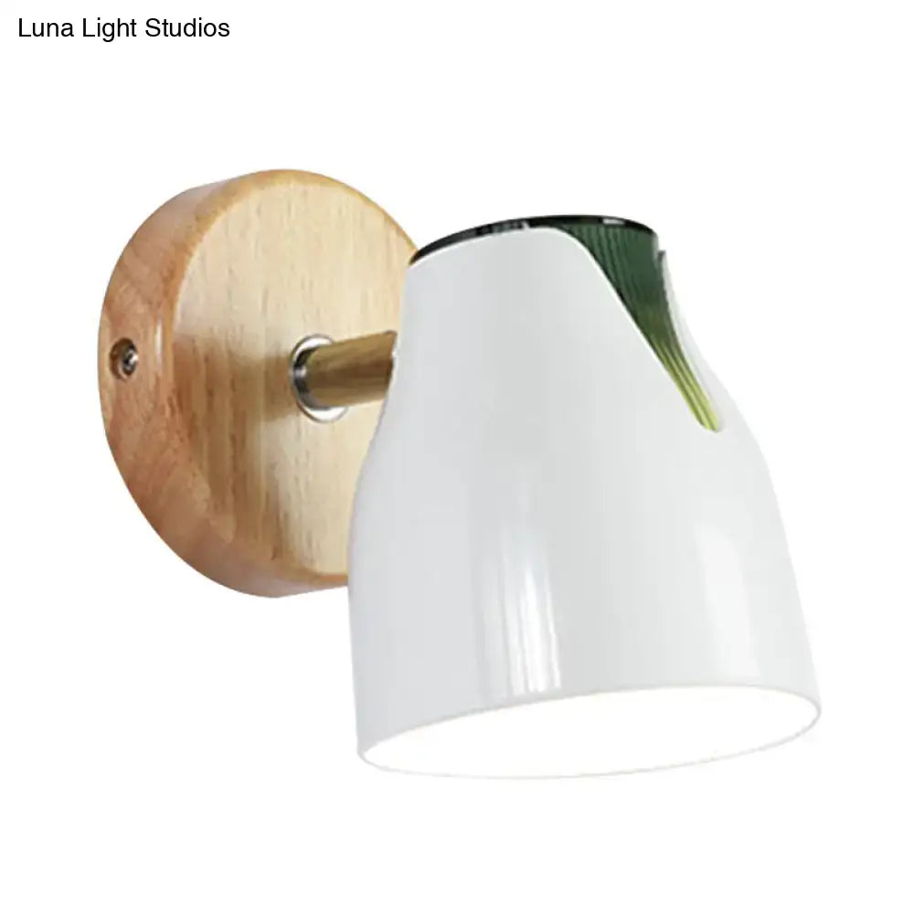 Modern wall light with white ceramic shade, natural wood backplate, green leaf accent, and metallic bud shade as light source