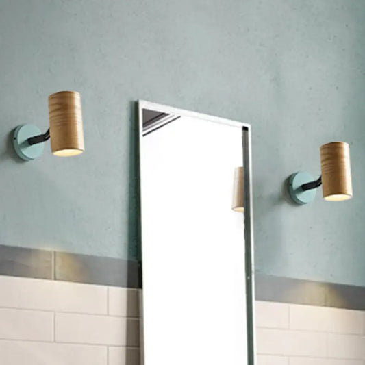 Pair of modern wood wall sconces with yellow green bases and light wood shades ideal for bathroom lighting