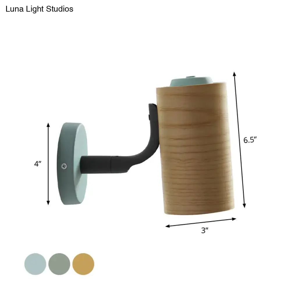 Modern wall-mounted lamp with cylindrical wooden body and black metal arm in yellow green for bathroom use