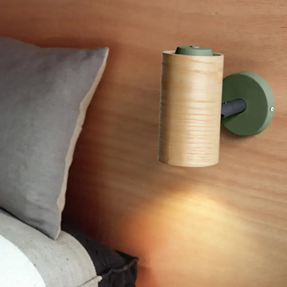 Modern wall sconce pair for bathroom with cylindrical wooden body and matte yellow green metal base