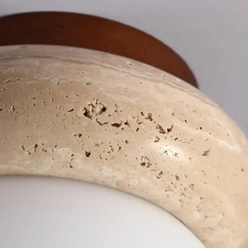 Beige stone bowl ceiling light with smooth textured surface and natural veins on modern wood base decorbites led ceiling