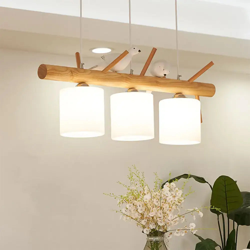 A rustic wooden branch-style pendant light with three white glass cylinder shades and bird décor for dining room lighting 220v-240v 110v-120v compatible