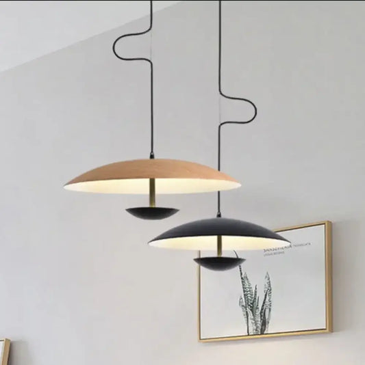 Modern wood and black ring pendant light with brass accent featuring two-tone disc shades and curved black cords