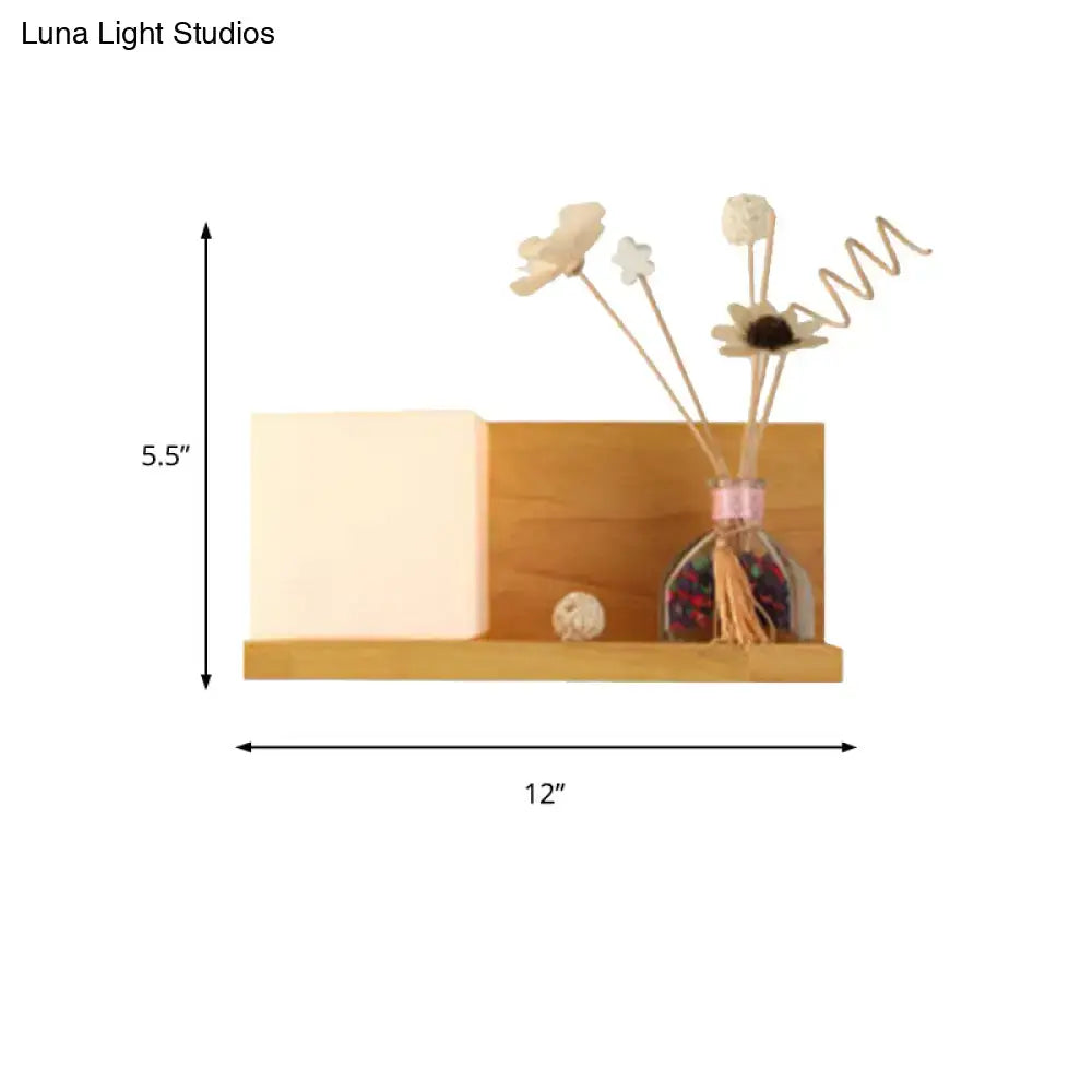 Modern wood floating shelf with beige wall lamp and warm sconce light holding minimalist diffuser and dried flowers