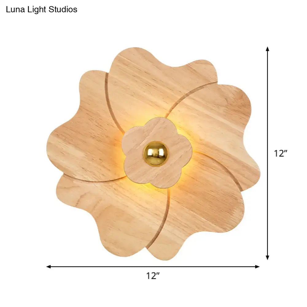 Modern wood flower wall light sconce with brass accent and warm glow featuring a 12-inch wooden flower design