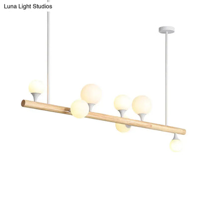Modern wood island lamp with natural wood beam and five frosted glass globe bulb bases for dining room lighting
