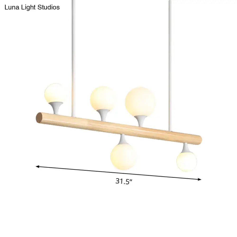 Modern wood island lamp with natural wood bar and five frosted glass globe bulb base for dining room lighting