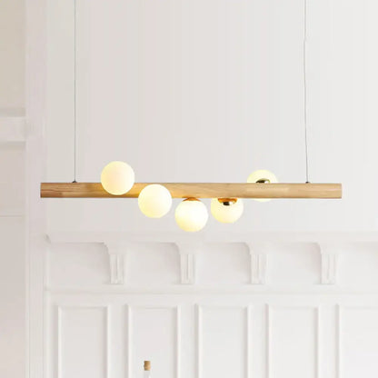 DecorBites modern wood island ceiling light with opal glass spherical shades and adjustable fixture height for dining room