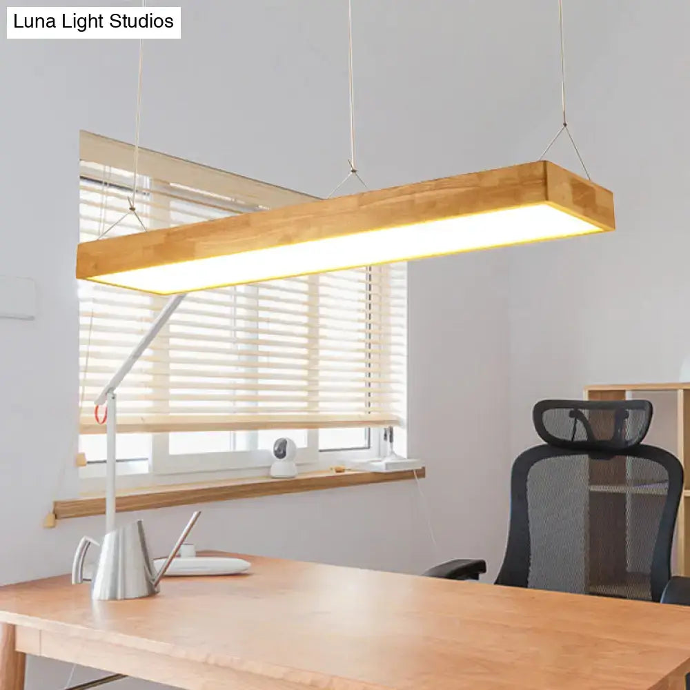 A modern wood rectangular ceiling light fixture with warm third gear illumination for a dining room setting