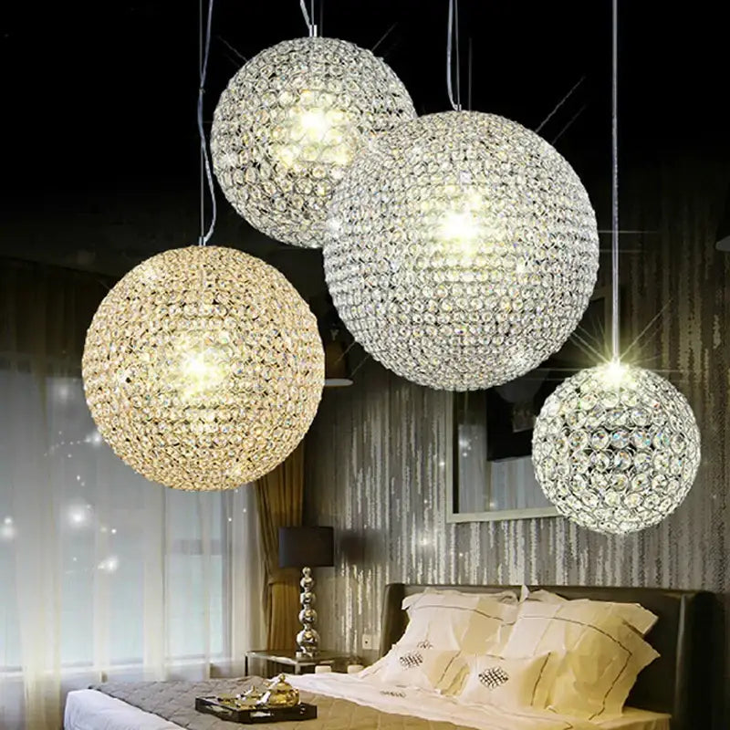 Four spherical crystal ball pendant lights with clear and gold crystals for modern dining room decorbites decor