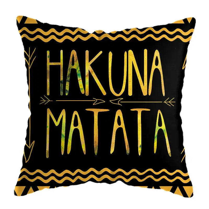 Black throw pillow with gold and green hakuna matata text and geometric patterns for modern geometric deer print decor