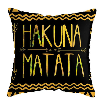 Black throw pillow with gold and green hakuna matata text and geometric patterns for modern geometric deer print decor