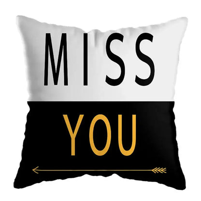 White and black throw pillow with miss you text and gold arrow accent for modern yellow and black geometric deer print living room