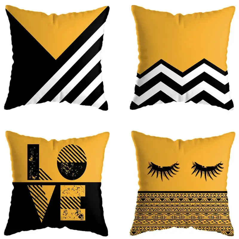 Set of four square throw pillows with bold yellow and black geometric deer print designs for living room decor