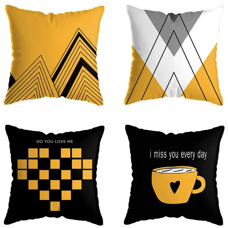 Set of four modern throw pillows with geometric deer print mountain designs in yellow black white and gray for living room