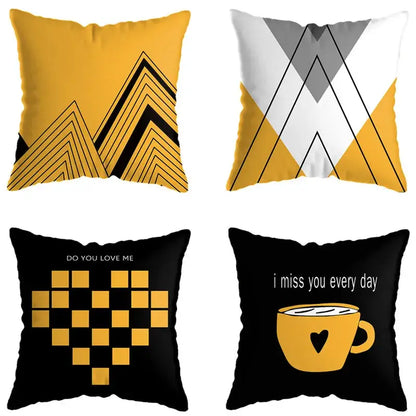 Set of four modern throw pillows with geometric deer print mountain designs in yellow black white and gray for living room