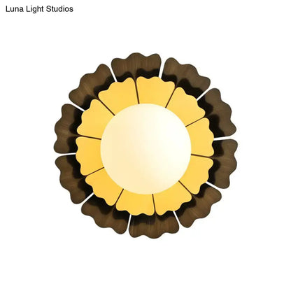 Modern yellow and brown sunflower wall sconce with a warm yellow glass center and layered brown petal shades for bedroom lighting