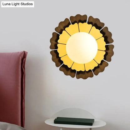 Modern yellow and brown sunflower wall sconce with layered petal glass design for bedroom lighting
