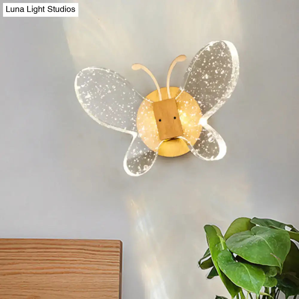 Modern yellow and clear butterfly bubble crystal sconce with sparkling translucent wings for bedroom lighting